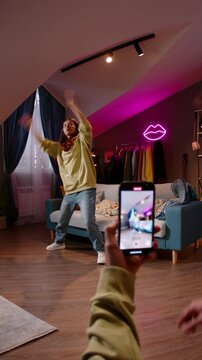 Young female dancer recording hip hop routine for contest presentation at home