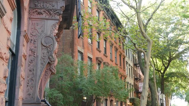New York City urban residential buildings architecture, Manhattan classic street, Greenwich village, United States of America. Typical red brick house in NYC, real estate property in USA. West village