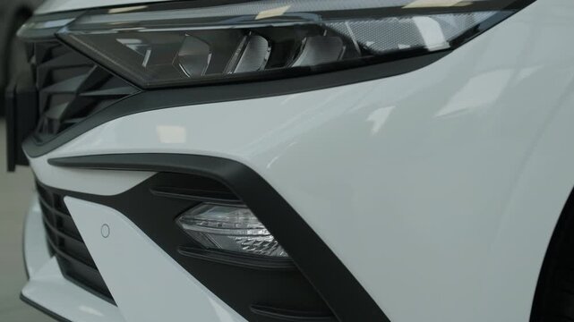 Front Three Quarter View of a Modern Silver Sedan Displayed in a Bright Auto Showroom