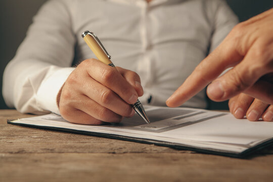 businessman signing contract in office