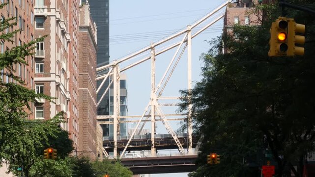 New York City Manhattan Midtown street, Queensboro bridge architecture, United States. Urban transport bridge and red brick residential buildings. Metallic bridge in East Side. Sutton Place traffic.