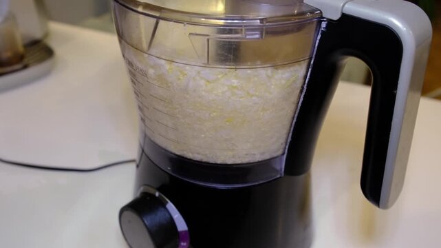 Front closeup shows cabbage pulsing inside a food chopper, measured bowl and dial visible in a clean home kitchen scene. Homemade slaws and sauerkraut cut additives and help budget friendly nutrition.