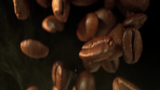 Super Slow Motion Macro of Coffee Beans Falling on Black Background at 1000fps.