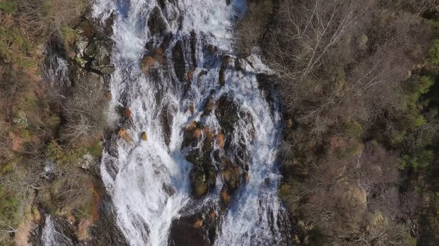 Flowing Waters Over Rugged Mountains At Fervenza das Bra&ntilde;as In Toques, Spain. Aerial Slow Motion Shot