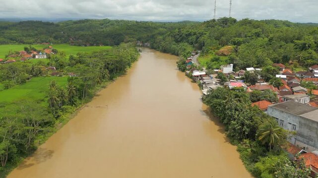 Muddy Brown River In Java Indonesia Sindangbarang Drone Rise 4K 60FPS
