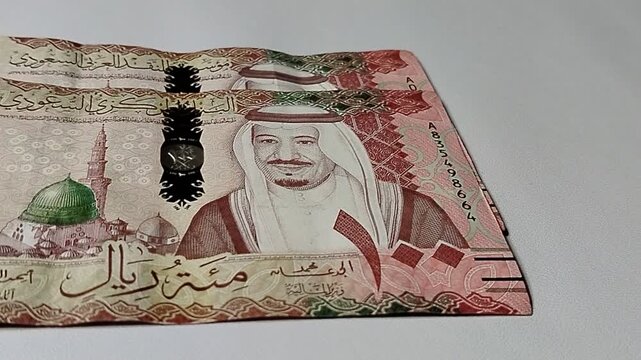 One hundred riyals banknote on financial background, symbolizing wealth management, banking system, and economic success concept.