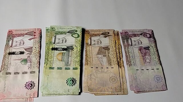 Saudi Riyal banknotes set featuring 5, 10, 50, and 100 riyals, symbolizing the economic strength and cultural identity of Saudi Arabia.