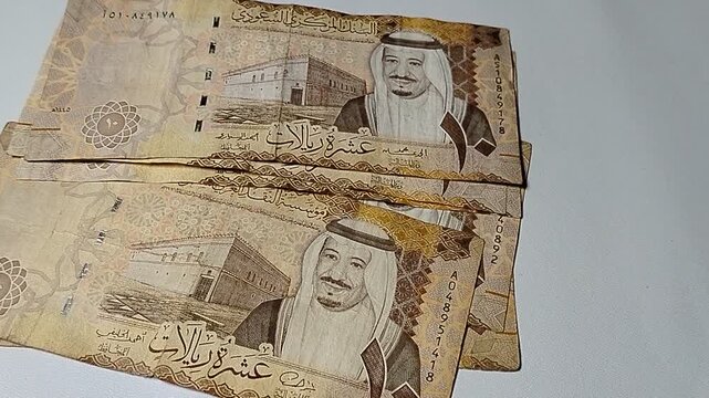 Ten riyals paper money on financial theme background, representing investment, banking, cash flow, and economic growth in Saudi Arabia.