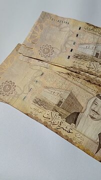 Ten riyals paper money on financial theme background, representing investment, banking, cash flow, and economic growth in Saudi Arabia.