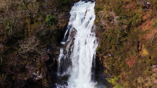 Stunning View Of Fervenza das Bra&ntilde;as Waterfall In Toques, A Coru&ntilde;a, Spain. Aerial Slow Motion Shot