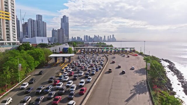Aerial shot with a drone moving forward towards a toll booth on the Corredor Sur in Panama City