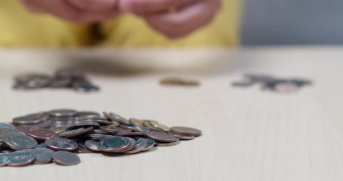 A detailed close-up view of hands counting coins showcasing financial organization and economic activity.