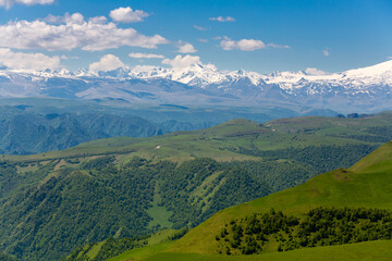 Fototapeta premium Landscape of Main Caucasus range and green mountain slopes at summer travel