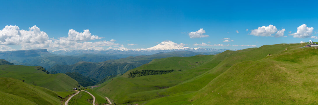Panoramic view of snow-capped mount Elbrus and foothills in Caucasus mountains