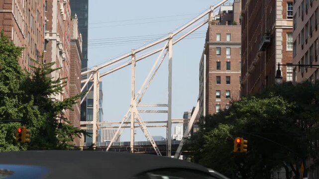 New York City Manhattan Midtown street, Queensboro bridge architecture, United States. Urban transport bridge and red brick residential buildings. Metallic bridge in East Side. Sutton Place traffic.