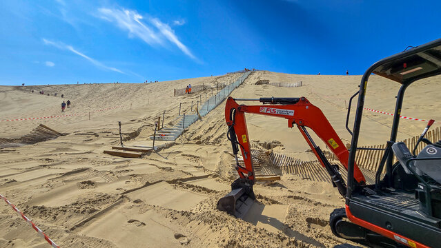 La Teste-de-Buch, Arcachon Bay, France - June 12, 2025. The building process of concrete stairs on the largest European Dune du Pilat at the Atlantic.
