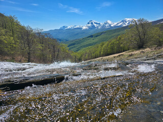 Water cascades at Cento Fonti in Monti della Laga with panoramic view of Gran Sasso mountain range, Abruzzo, Italy © Buffy1982