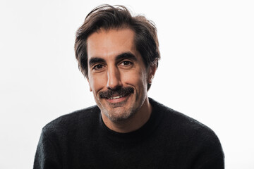 Fototapeta premium Captivating smile of a man in a cozy sweater against a soft backdrop