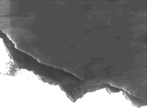A close-up view of a torn paper edge with a rough texture