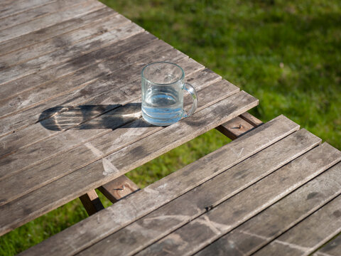mug of still water on the garden table