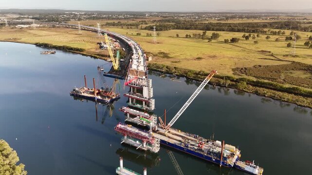 Aerial drone view of the M1 Pacific Motorway Extension project at Tomago, Newcastle, NSW Australia crossing over Hunter River in May 2026