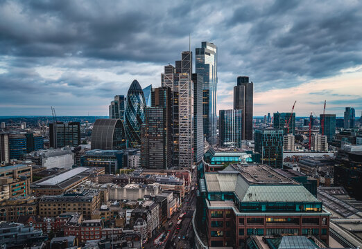 Panoramic aerial view of the illuminated City of London skyline with office skyscrapers and street traffic at Bishopsgate and Liverpool Street