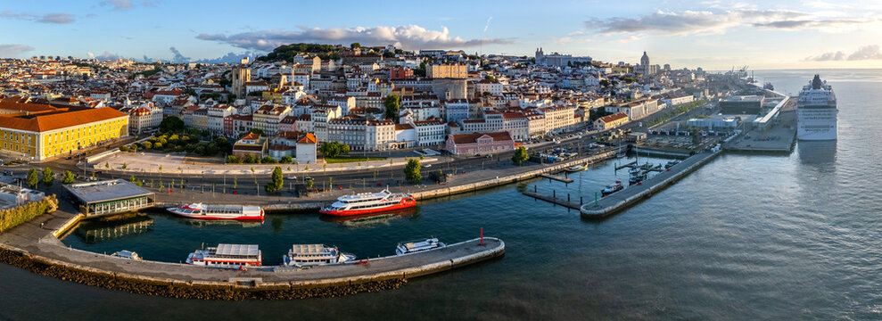 Aerial view of Lisbon Cruise Port - Jardim do Tabaco Quay and the historic city skyline along the Tagus River under a soft golden light Lisboa, Lisboa, Portugal.