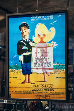 Saint-Tropez, France - December 8, 2025: Vintage movie poster of the film Le Gendarme de Saint Tropez featuring Louis de Funes displayed in a shop window in the city center