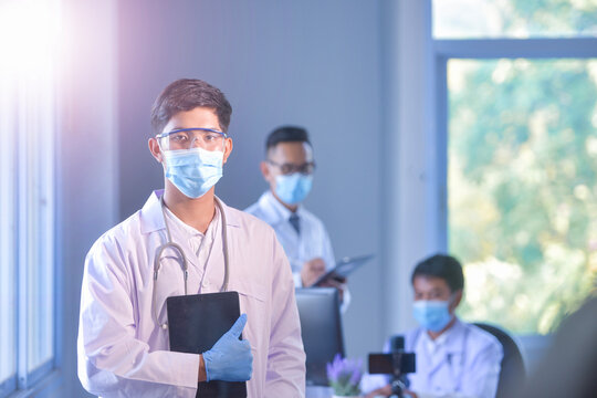 Portrait of three doctors wearing face masks in a hospital office
