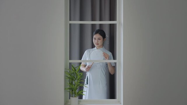 Portrait woman wearing traditional chinese style cheongsam dress, elegant sophisticated. Female serene expression complements intricate design of her attire style for fashion, culture, celebration.