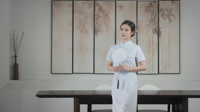 Young woman wearing traditional chinese style cheongsam dress, elegant sophisticated. Female serene expression complements intricate design of her attire. Portrait of grace style for fashion, culture