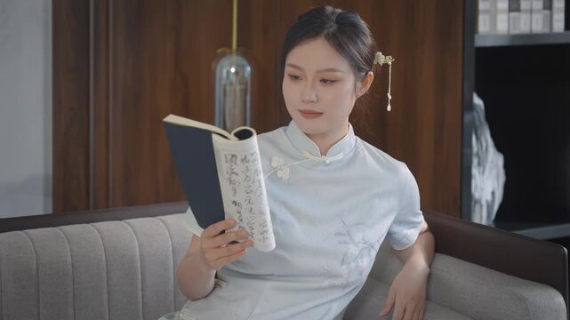 Elegant young woman lady in retro traditional beautiful cheongsam dress costume lady, girl enjoying history chinese culture have good weekend drinking tea study at home