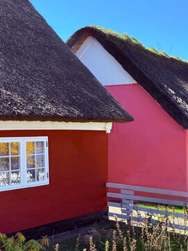 Close-up of two traditional colourful Danish houses with thatched roofs, Fano, Jutland, Denmark