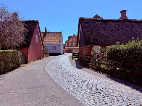 Empty cobbled street through Nordby village on a sunny spring day, Fanoe, Jutland, Denmark