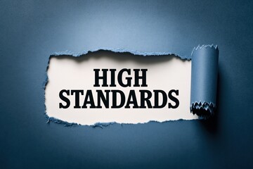 Naklejka premium High Standards a principle for excellence revealed from under torn paper