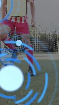 Vertical video: Teen boy starting on ball tap, training soccer control as blue overlay marking feet