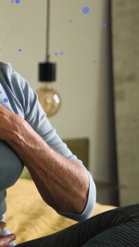Vertical video: Woman with headphones playing, chest-breathing, blue particles drifting for health
