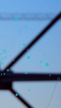 Vertical video: Turquoise dots appearing, camera pulling back, revealing pylons across sunset ridge