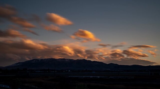 Saratoga Springs as seen from Lehi, Utah at sunset in spring - colorful twilight to darkness time lapse cloudscape