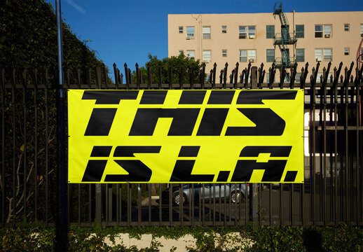 Mockup Template for Horizontal Urban canvas Poster displayed on a fence in Los Angeles