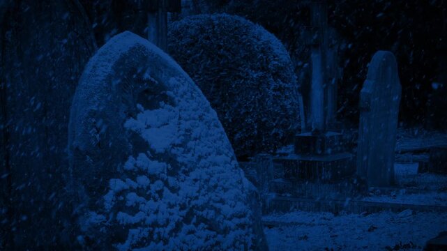 Snow Covered Gravestone In Cemetery At Night