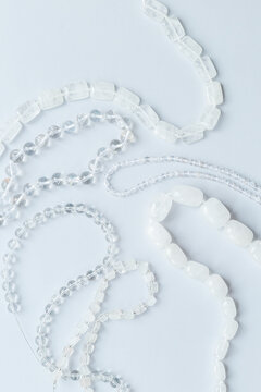 Flat lay of many rock crystal beads for jewelry, top view. Gemstones background