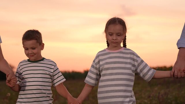 mother father children boy girl park sunset, man woman toddlers outdoors, Sure Here are 10 options for image titles in English, separated by commas:
