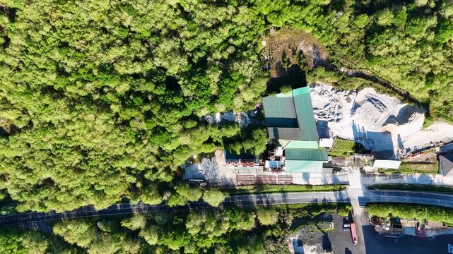 Aerial top down view of industrial quarry and forest
