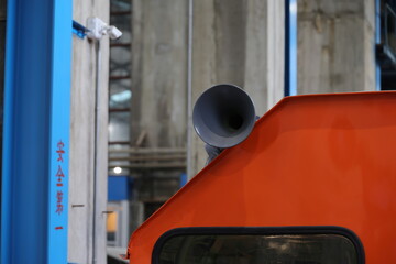 A grey train horn on an orange locomotive roof. © eric1207cvb