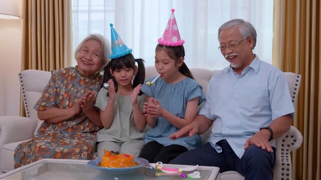Family Birthday Joy: A heartwarming moment of intergenerational celebration, with a joyous family gathering. A cheerful pair of young children celebrating a special day with their grandparents.