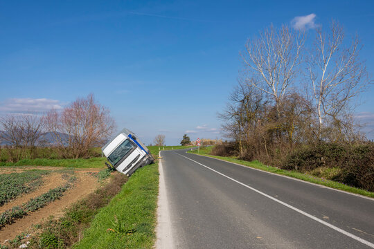 A tarpaulin truck went off the road after a bend