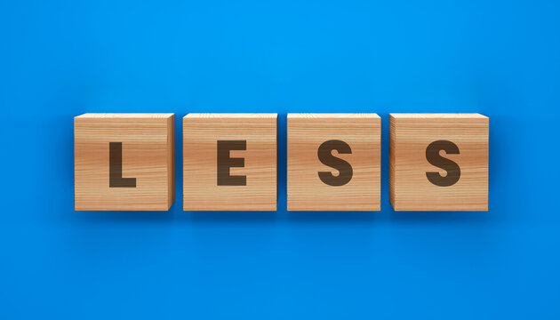 The Art of Reduction: Wooden blocks arrange to spell out LESS, offering a thought-provoking visual for various contexts.