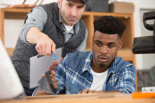 instructor with apprentice in workshop