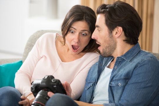 couple shocked by photograph on camera screen